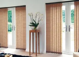 Copper-toned vertical blinds over French doors in a bright living room