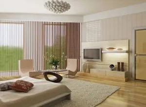 Beige and brown vertical blinds in a spacious bedroom with hardwood floor