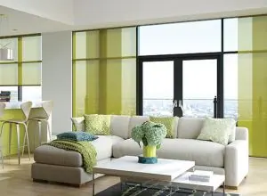 Lime green sliding panels beside large glass doors and a white sofa