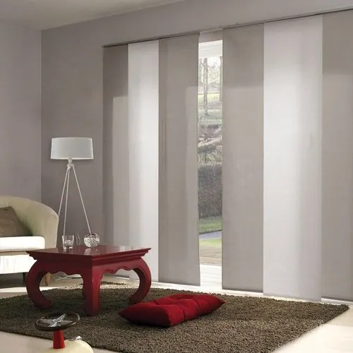 Pale grey sliding panels with a red coffee table and brown rug