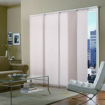 Pale pink sliding panels in a lounge with white chair and city view