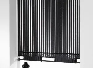 Black roller blind with thin white vertical stripes and a bottom bar
