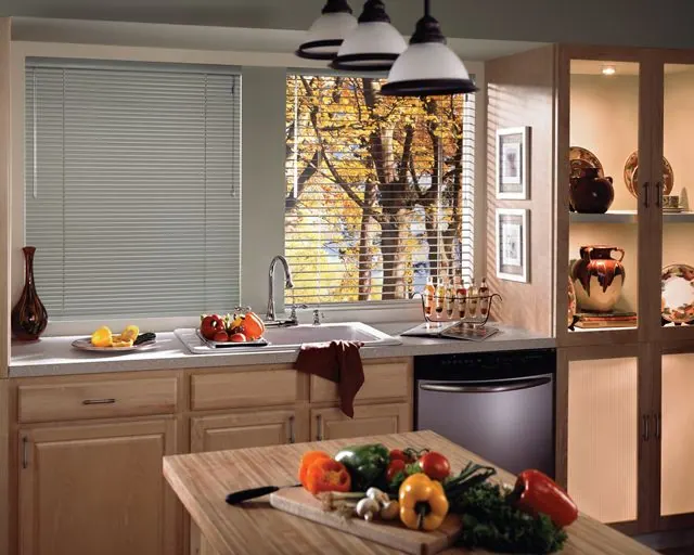 White slat horizontal blind in a kitchen with a wooden island