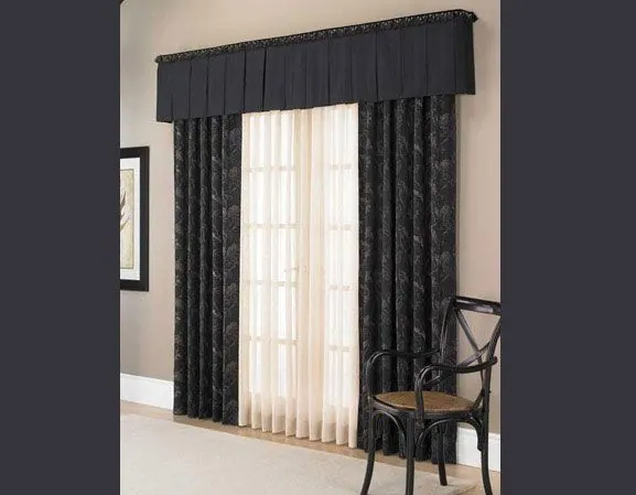 Black valance, embroidered black drapes and cream sheer with a black chair