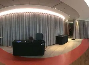 Large curved grey curtains in an event space with a red floor ring