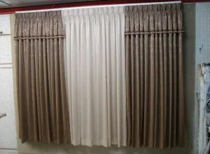Pleated brown, white and taupe curtains hung as a display sample